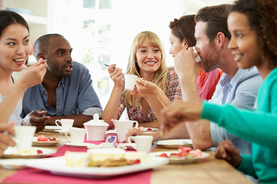 People having a party and enjoying coffee and treats