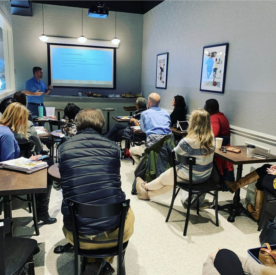 A group of people having a meeting at The Perc in one of our rental rooms